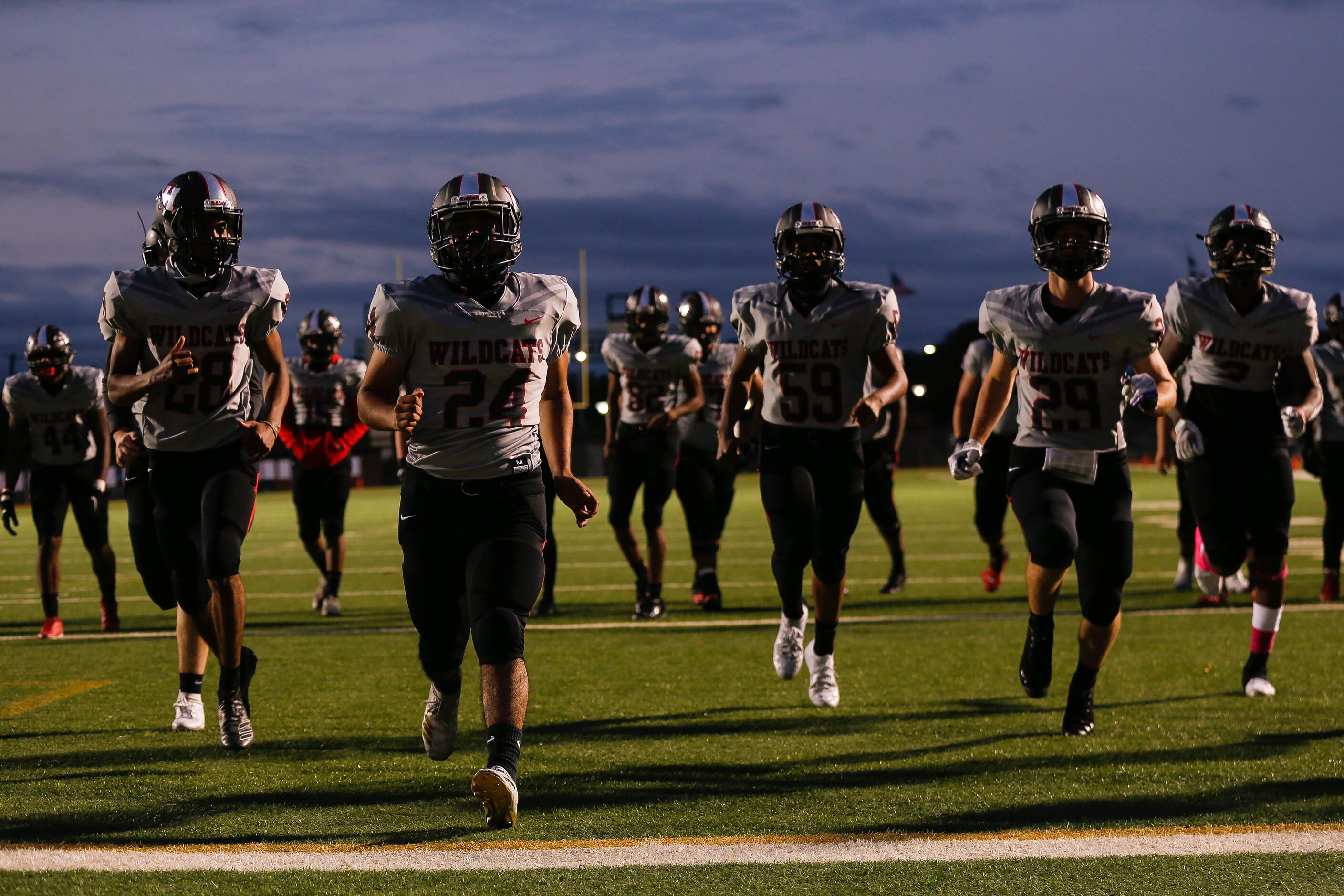 Lake Highlands High School players stretch before a football game against Irving MacArthur...