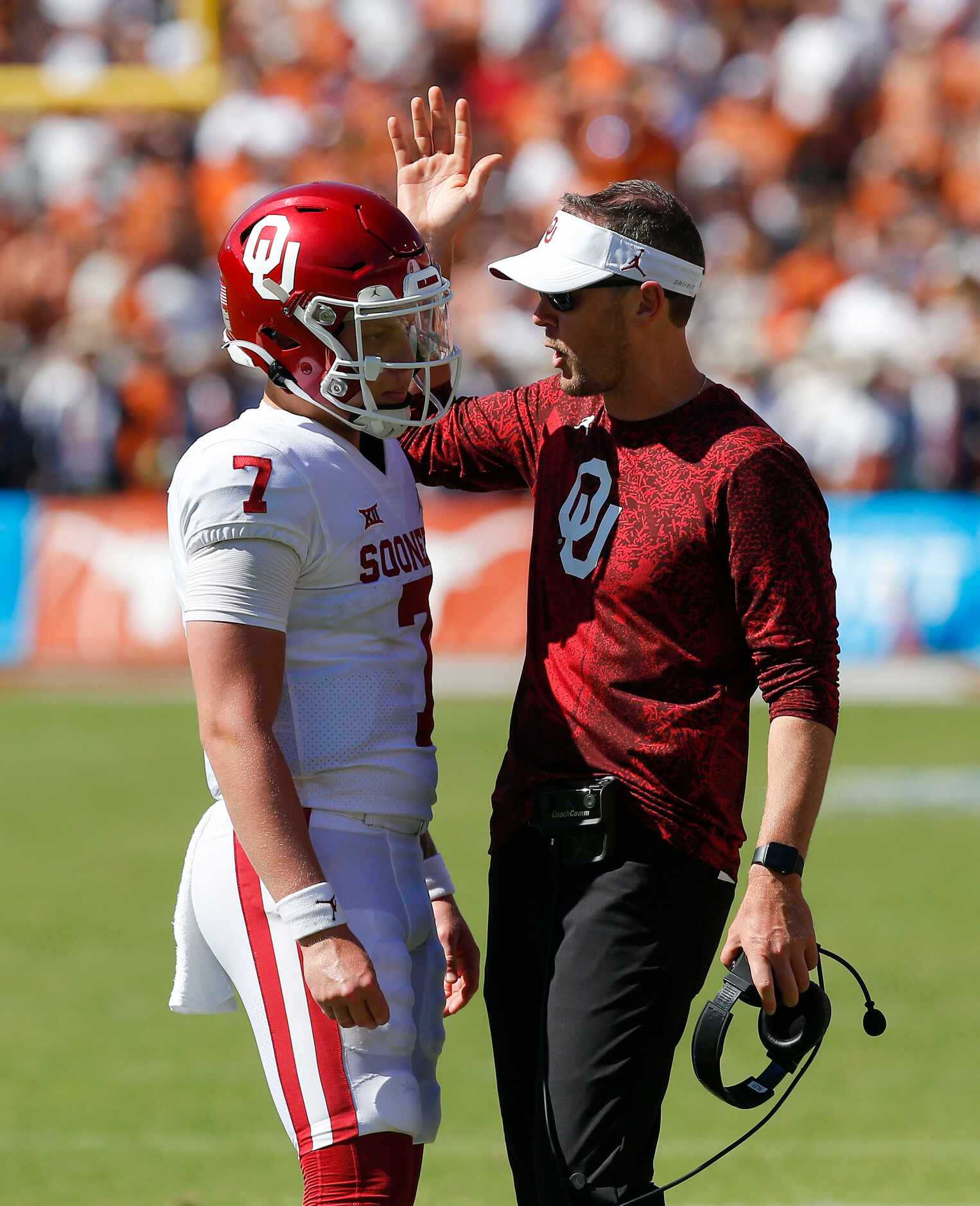 Oklahoma head coach Lincoln Riley reviews a play with Oklahoma quarterback Spencer Rattler...