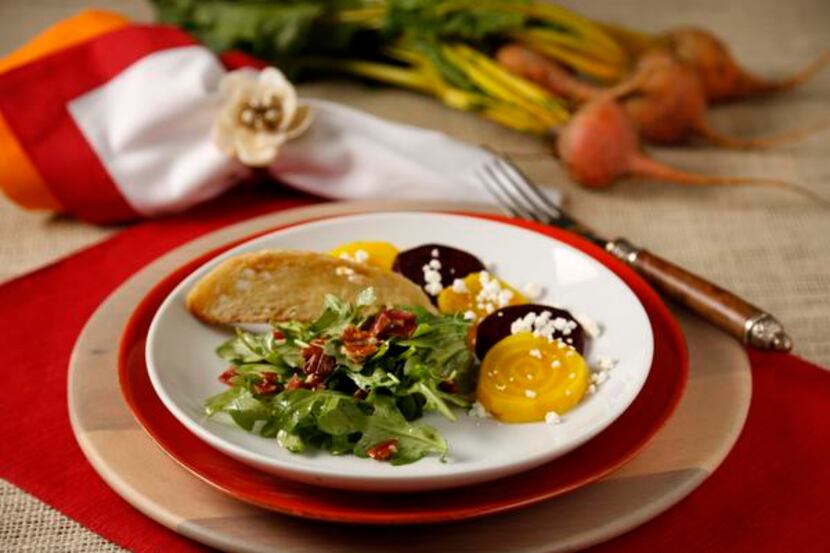 
Slices of yellow and red beets pair with arugula for an appetizing salad. 

