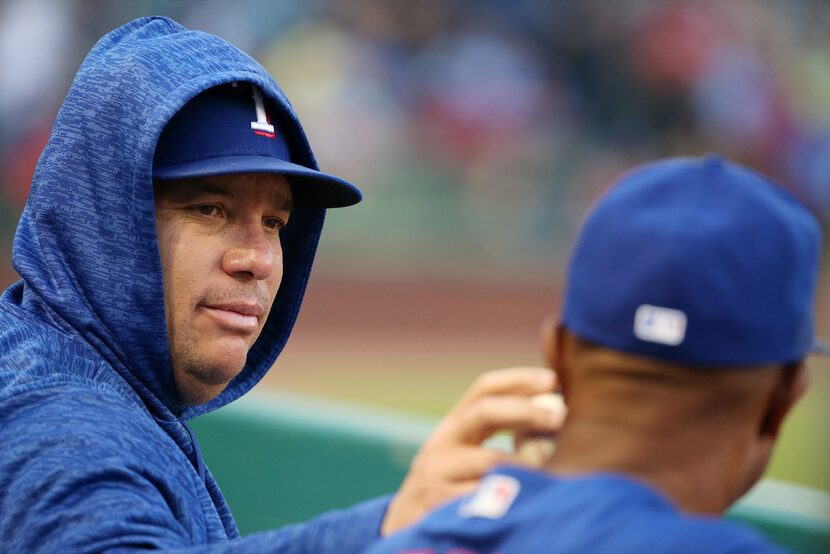 Texas Rangers starting pitcher Bartolo Colon (40) touches a ball to the neck of Texas...