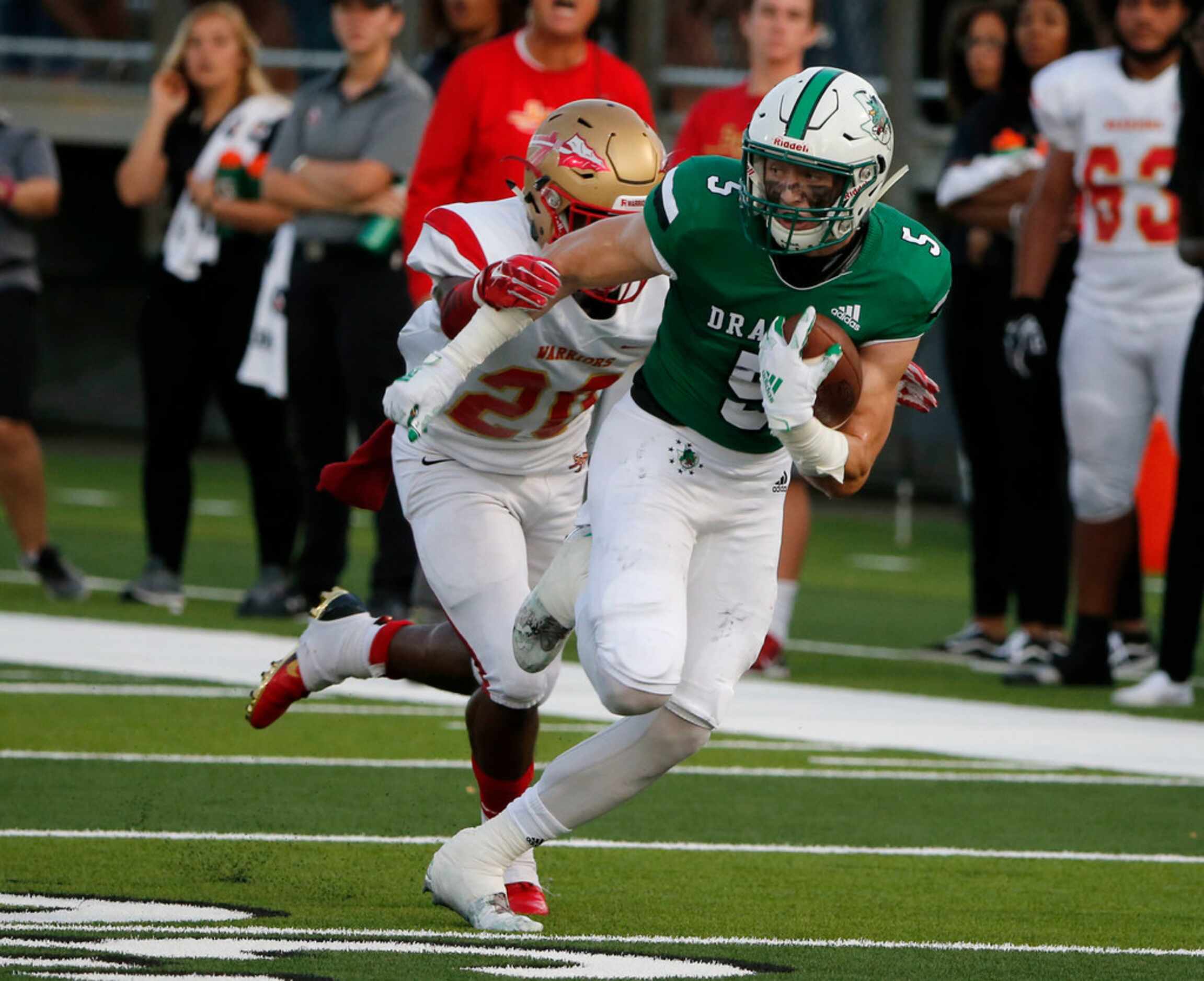 Southlake Carroll's Wills Meyer (5) tries to get away from South Grand Prairie defender...