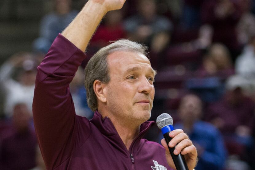 Texas A&M head football coach Jimbo Fisher waves to the crowd at Reed Arena during a timeout...