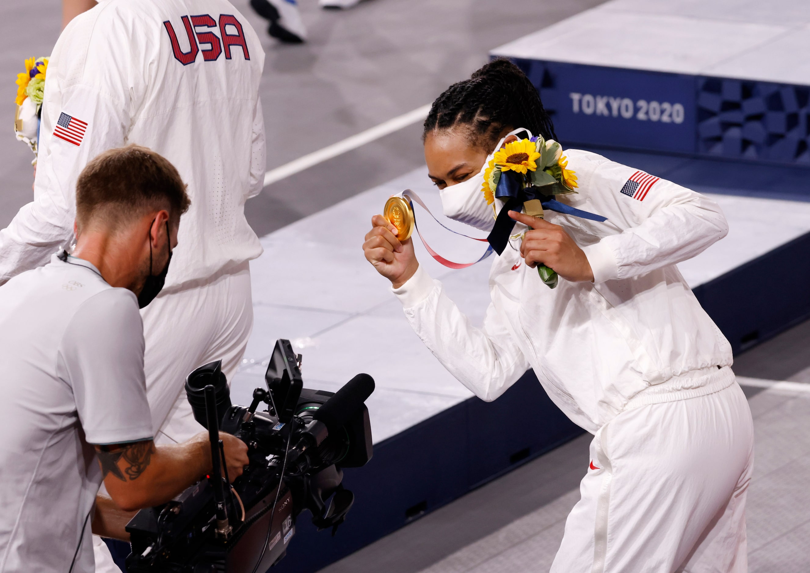 USA’s Allisha Gray (15) has fun with a camera during the medal ceremony for the 3x3 women’s...