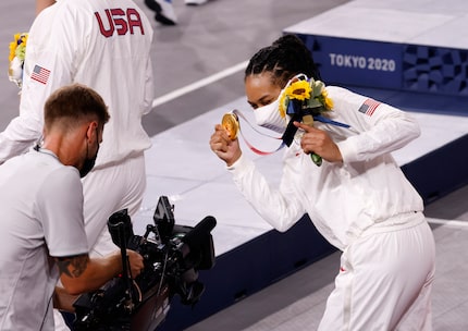 USA’s Allisha Gray (15) has fun with a camera during the medal ceremony for the 3x3 women’s...