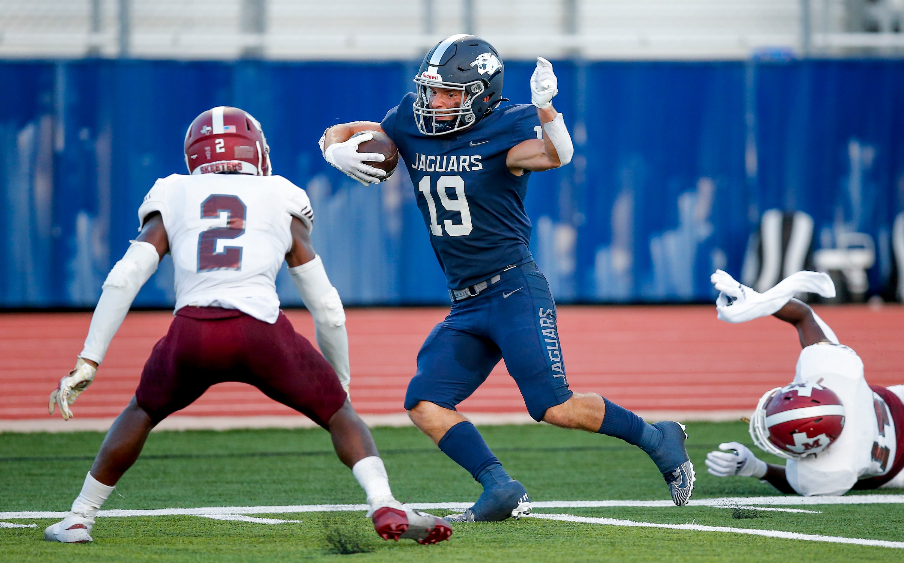 Flower Mound senior wide receiver Cade Edlein (19) looks for room against Mesquite senior...