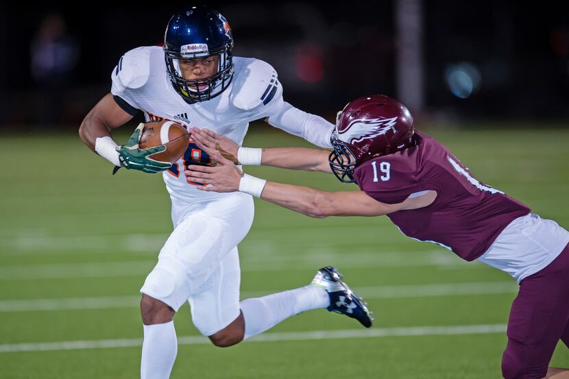 Rowlett defensive back Dylan Bauer (19) reaches for the ball as Sachse receiver Donovan...