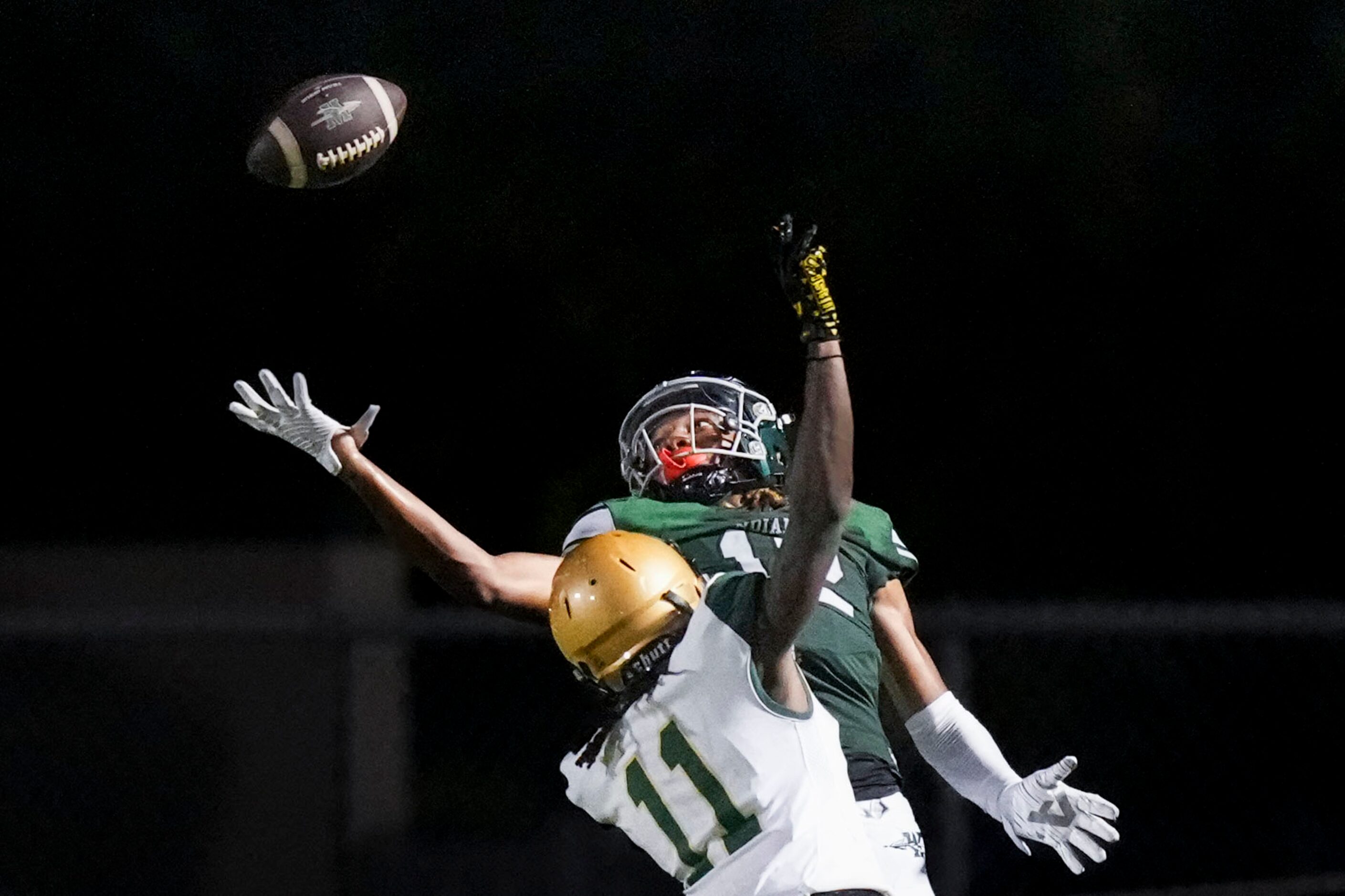 Waxahachie wide receiver Michael Esparza Jr. (12) tips the ball up and comes down with a...