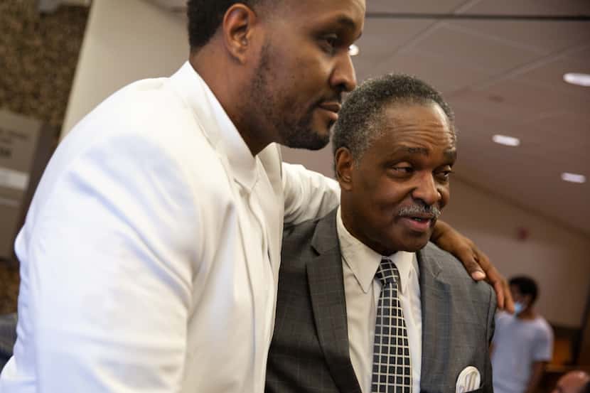 David Glover holds his brother Kenneth R. Harris Sr. after they gave their victim impact...