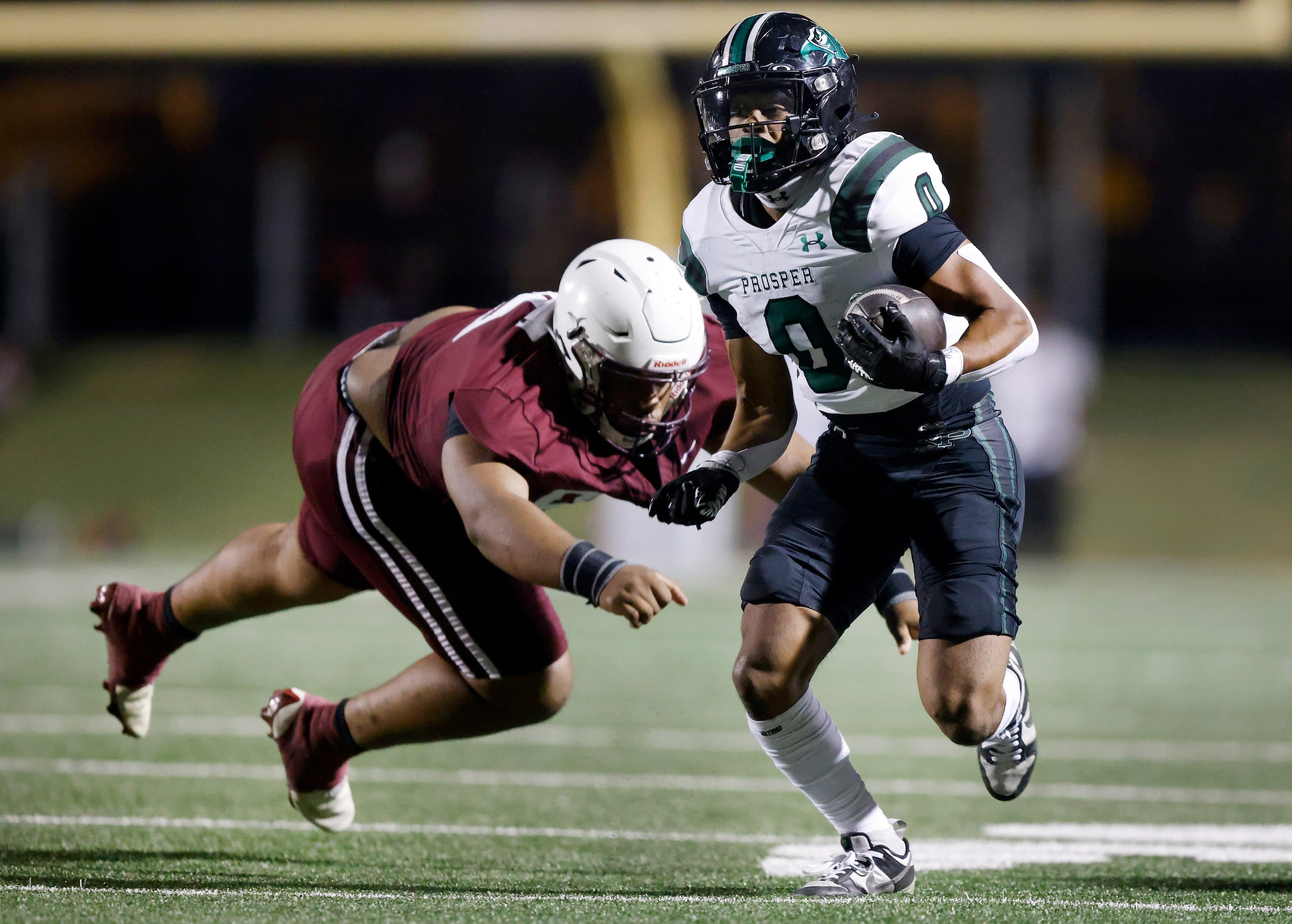 Prosper High Leo Anguiano (0) sheds a tackle attempt by Plano High’s Jaylyn McKinney (95)...