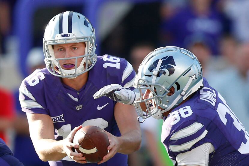 Kansas State quarterback Jesse Ertz (16) hands off to fullback Winston Dimel (38) in the...