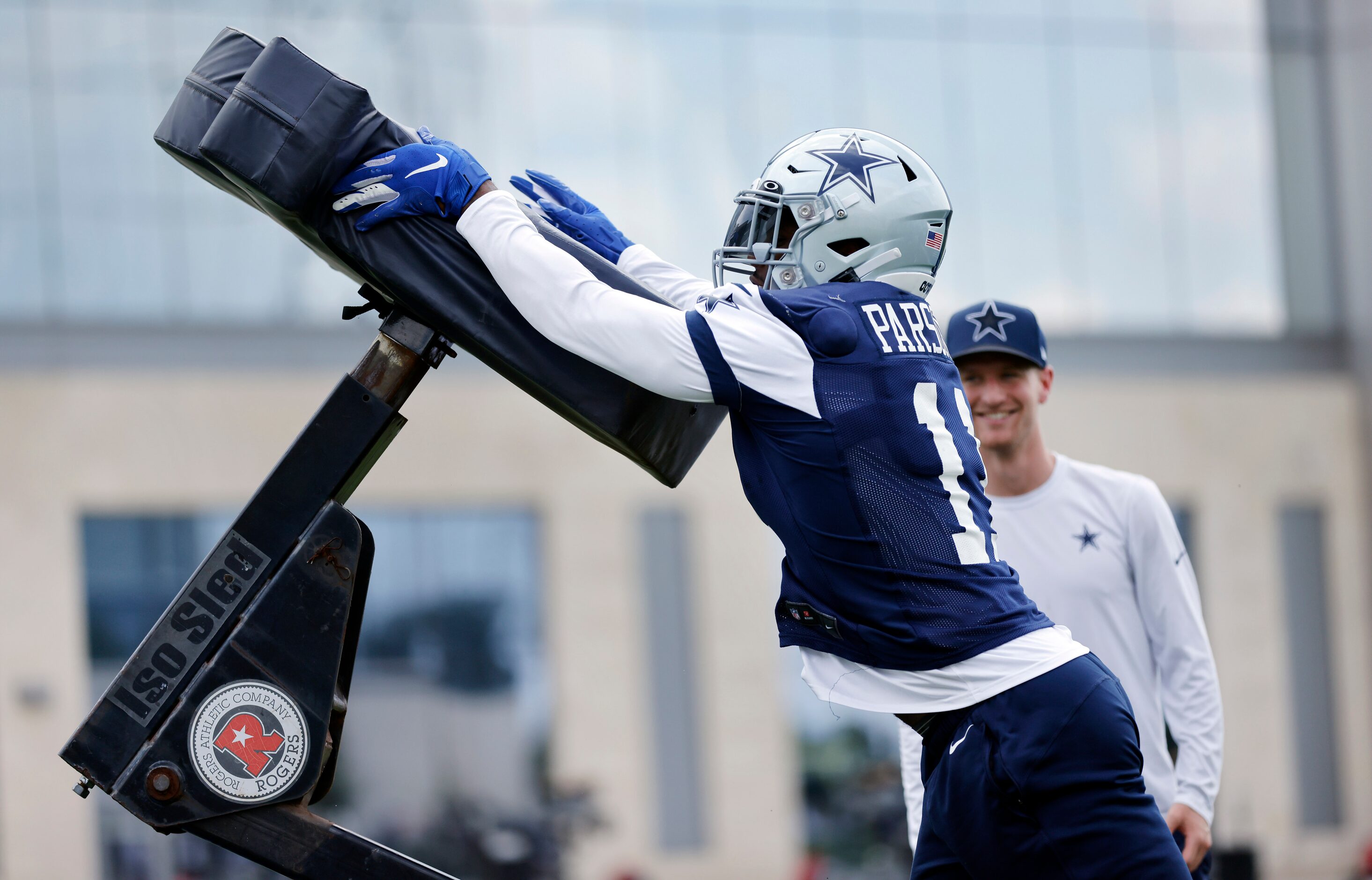 Dallas Cowboys linebacker Micah Parsons (11) pushes off a blocking dummy during a training...