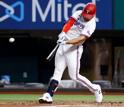 Texas Rangers batter Nate Lowe (30) connects on a two-run homer during third inning against...