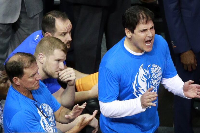 Dallas Mavericks owner Mark Cuban questions an officials call on his team in the third...