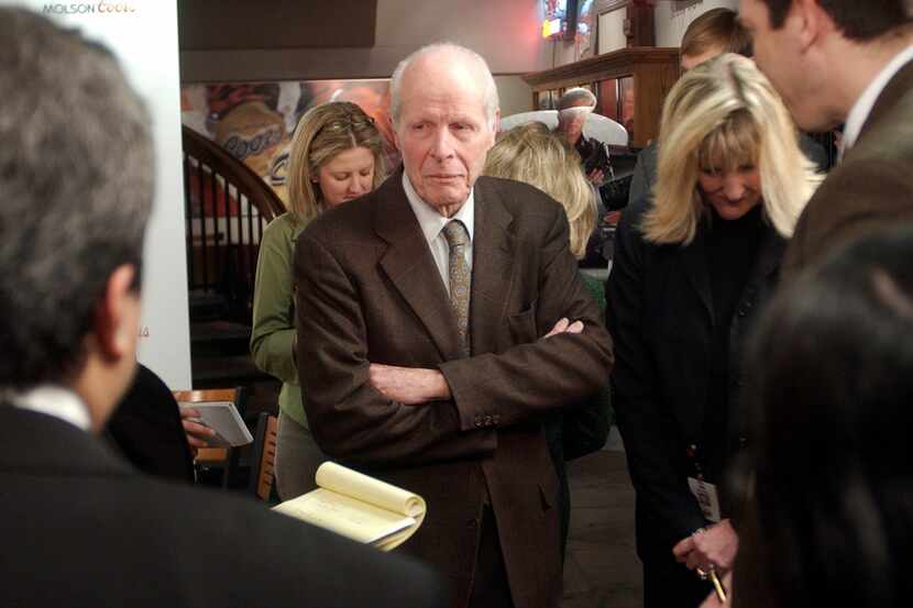 William "Bill" Coors, center, talks about the merger between Molson and Coors after a news...
