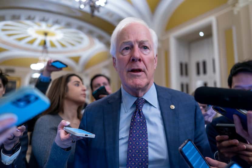 Sen. John Cornyn, R-Texas, is surrounded by reporters as he heads to the chamber during a...