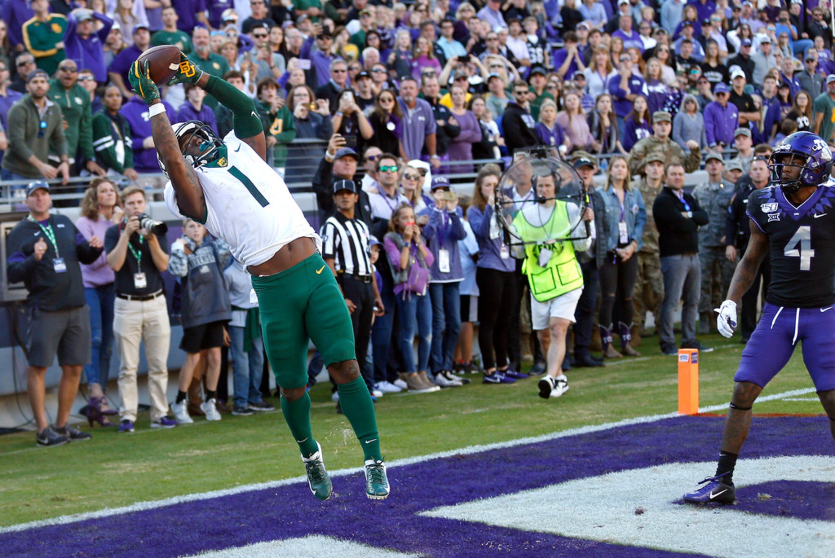 Baylor cornerback Grayland Arnold (1) intercepts the ball as TCU safety Keenan Reed (4)...