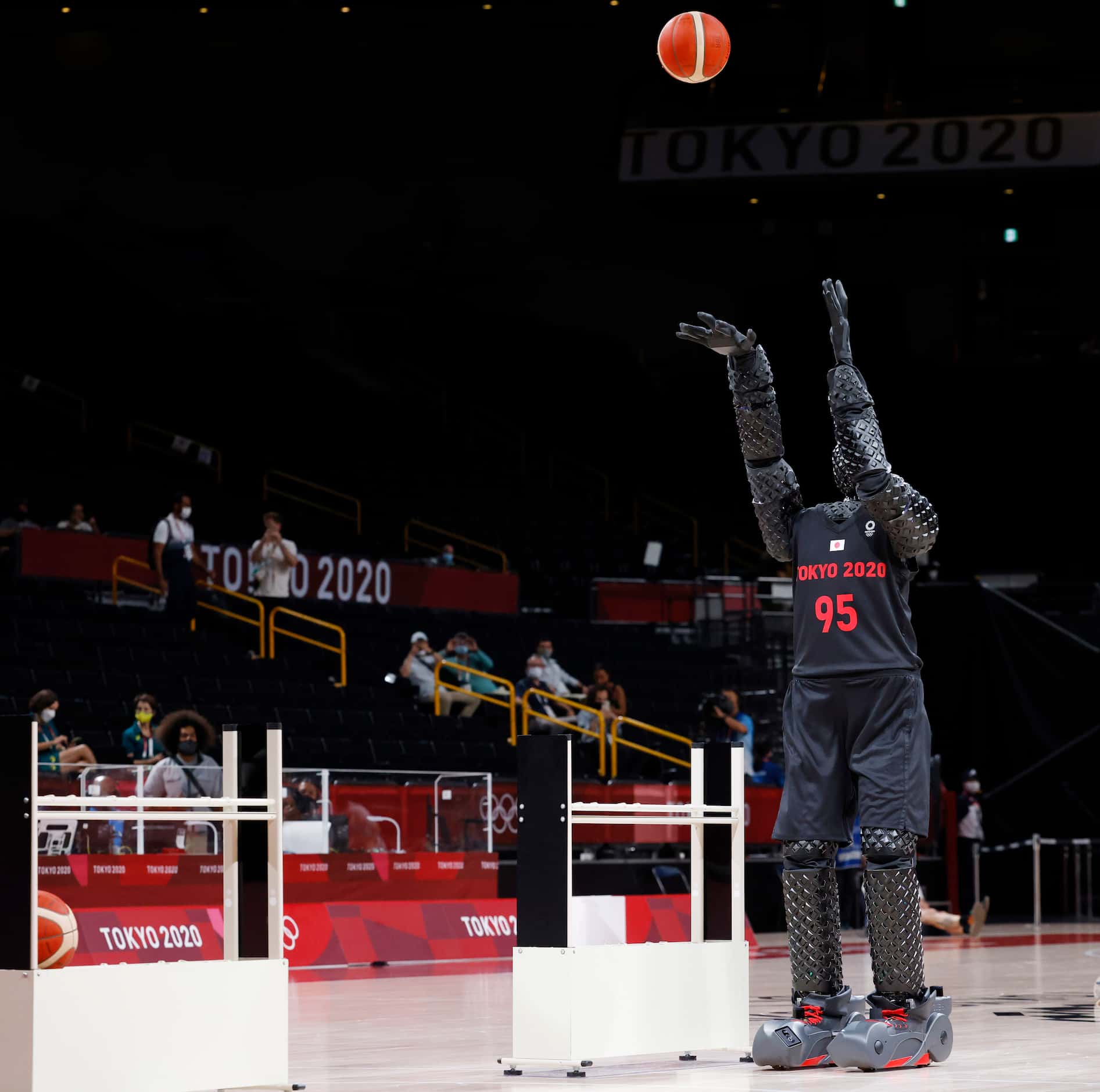 A robot shoots a basketball prior to the start of a game between USA and Australia for a...