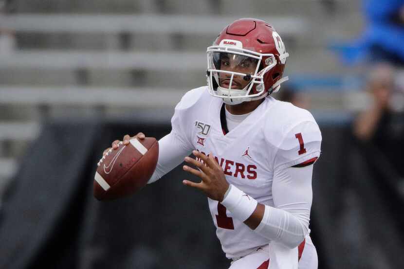 Oklahoma quarterback Jalen Hurts looks for a receiver during the first half of an NCAA...
