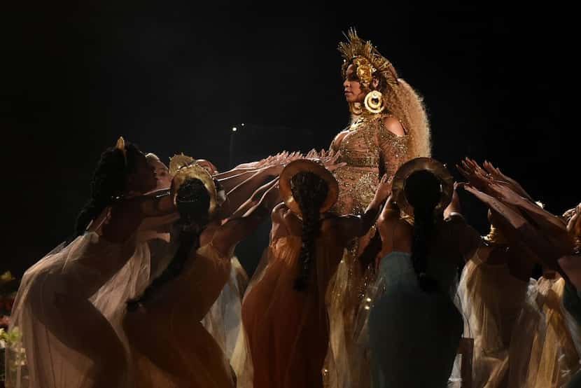 Beyonce performs as she is pregnant with twins during the 59th Annual Grammy music Awards on...
