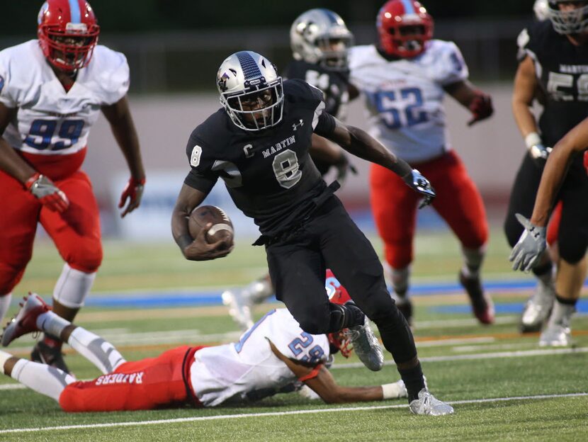 Martins Juma Otoviano, 8, works up field against  Skylines Eriq Senters, 29,  in game...