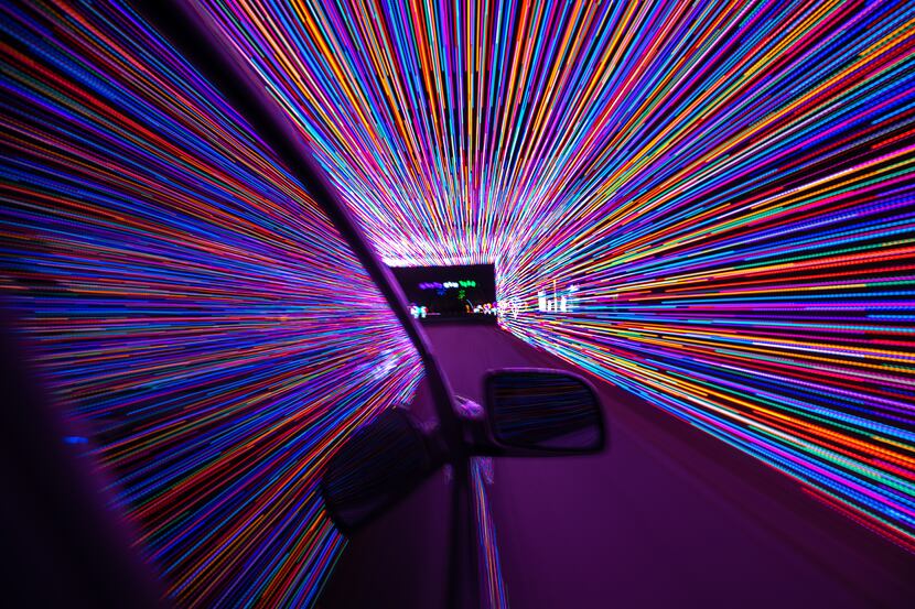 A vehicle travels through the Christmas light tunnel at this year's Prairie Lights holiday...