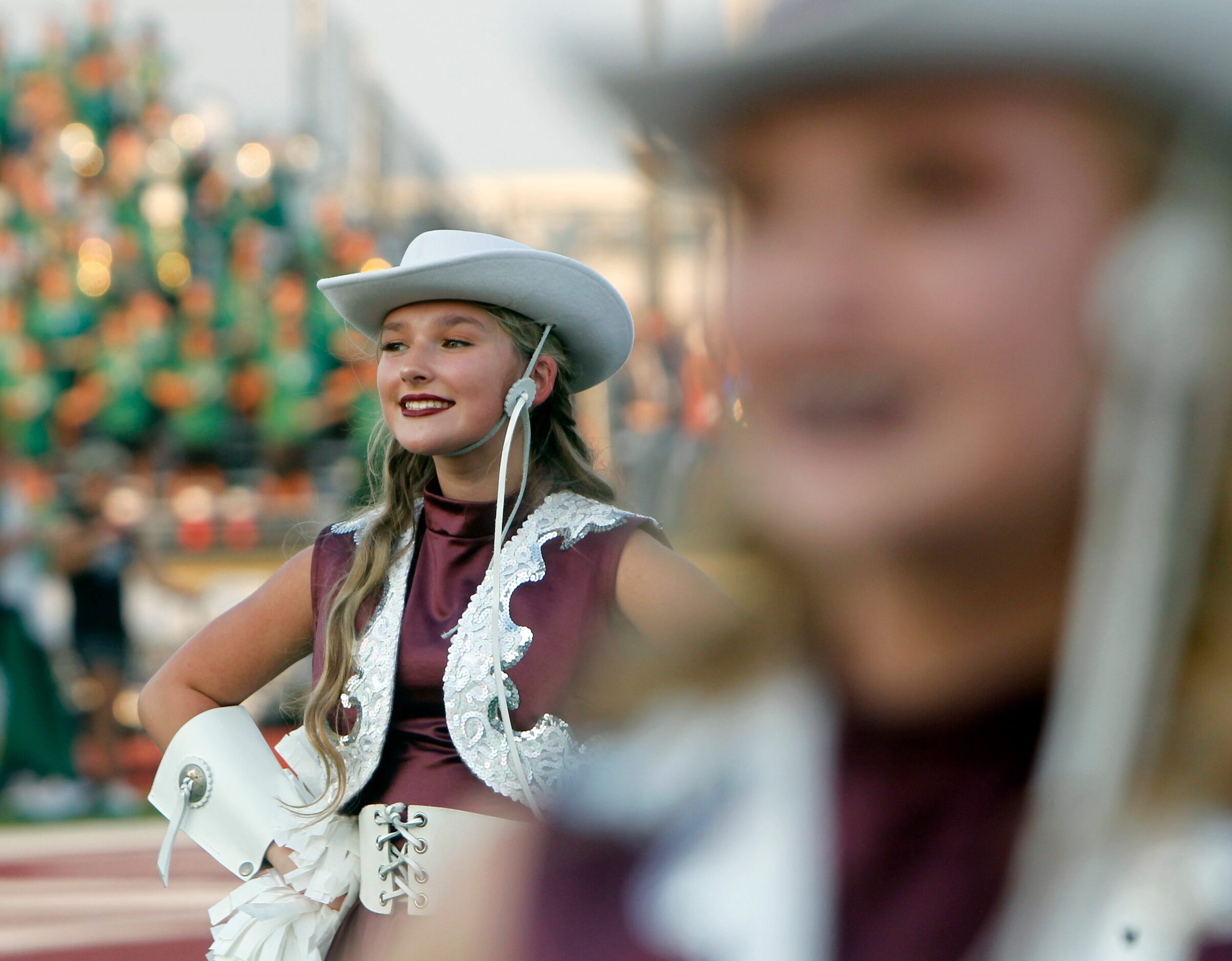 An Ennis drill team member awaits team introductions on the field prior to the opening...