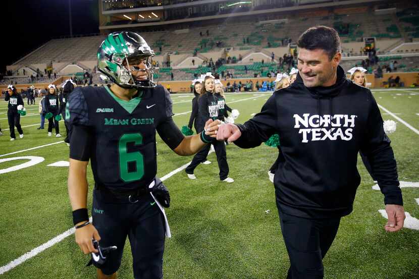 FILE - North Texas Mean Green head coach Seth Littrell fist bumps quarterback Mason Fine (6)...