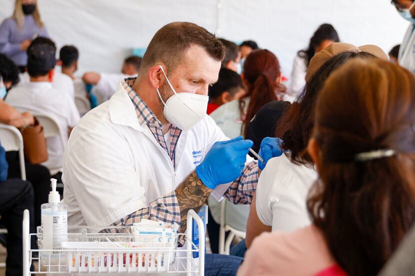 Pharmacy clinical services manager Rob Wheeler administers a COVID-19 vaccine at a...