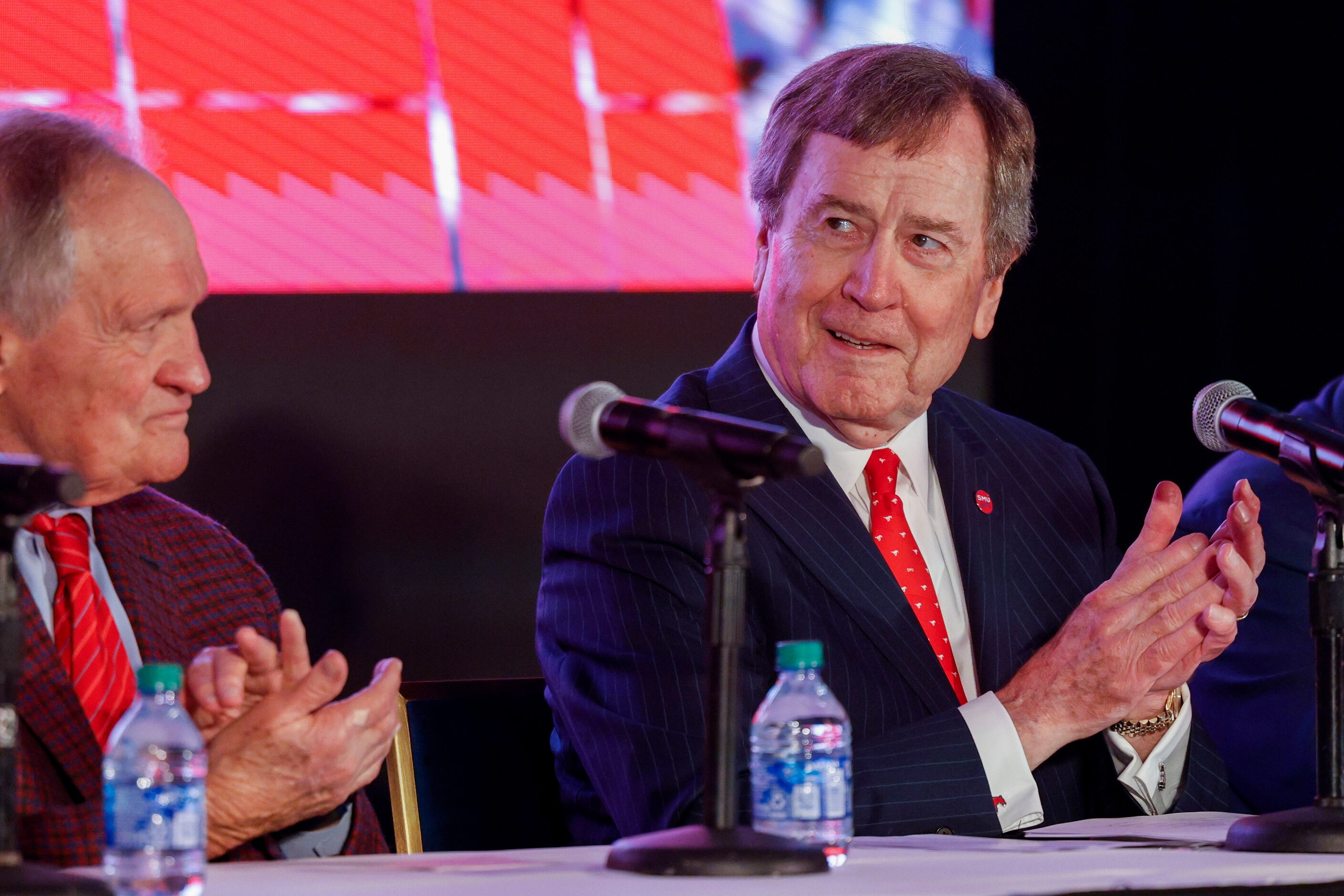 SMU President R. Gerald Turner (right) claps alongside SMU alumnus Garry Weber during a...