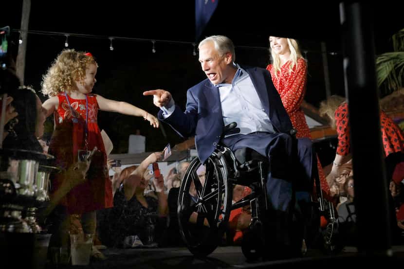 Texas Governor Greg Abbott points to young supporter in the front row as he arrives to make...