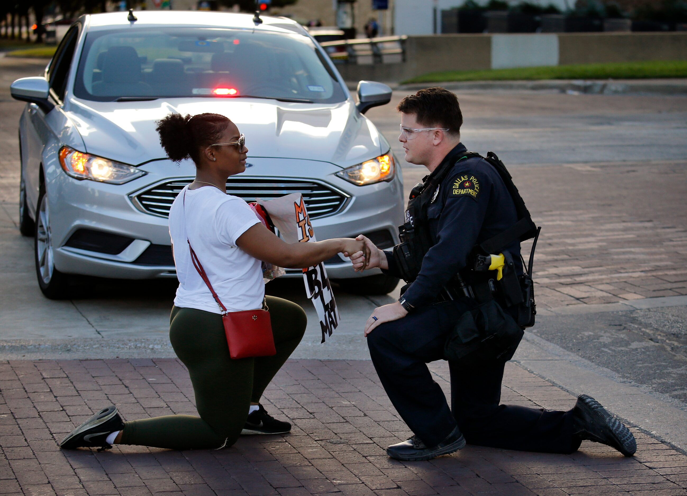 Protestor Slowanna Delavontae (left), who lives in the South Dallas area of Dallas, shakes...