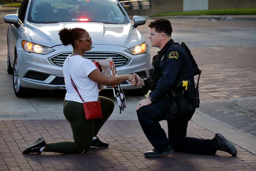 Protestor Slowanna Delavontae (left), who lives in the South Dallas area of Dallas, shakes...