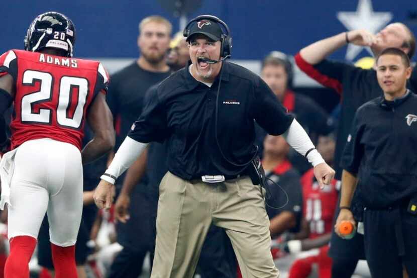 Atlanta Falcons head coach Dan Quinn celebrates after his defense sacked Dallas Cowboys...