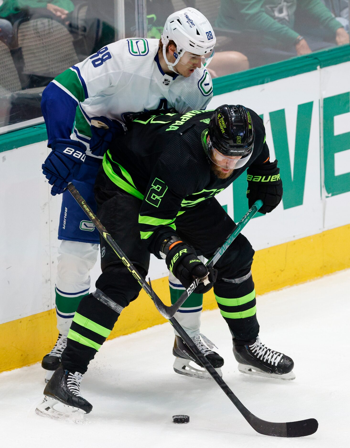 Dallas Stars defenseman Jani Hakanpää (2) shields Vancouver Canucks center Nils Aman (88)...