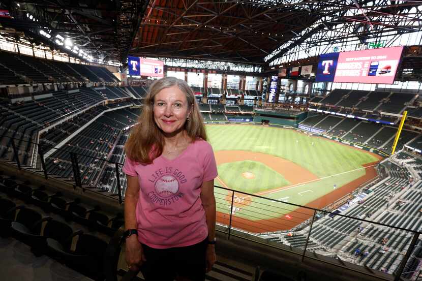 Season ticket holder Pam Lunk of Arlington, watches the Texas Rangers play during an MLB...