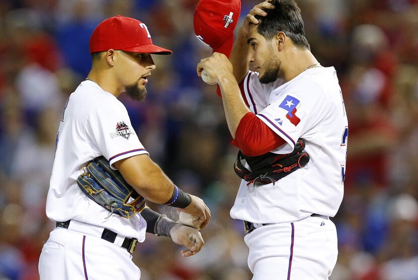 Texas Rangers second baseman Rougned Odor (12) checks on Texas Rangers starting pitcher...