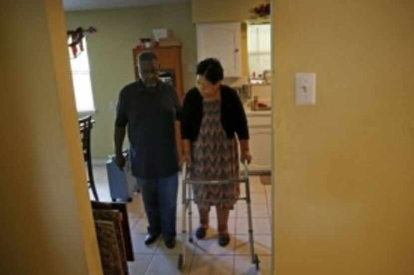  Charlie Wilson helps his wife, Debra Wilson, walk at their Duncanville home. (Jae S. Lee/...