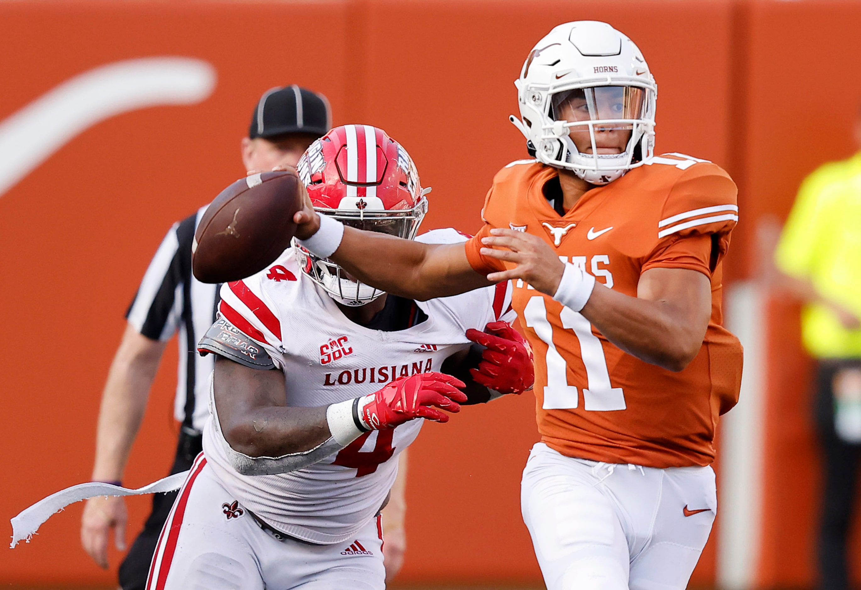 Texas Longhorns quarterback Casey Thompson (11) escapes the pass rush of Louisiana-Lafayette...