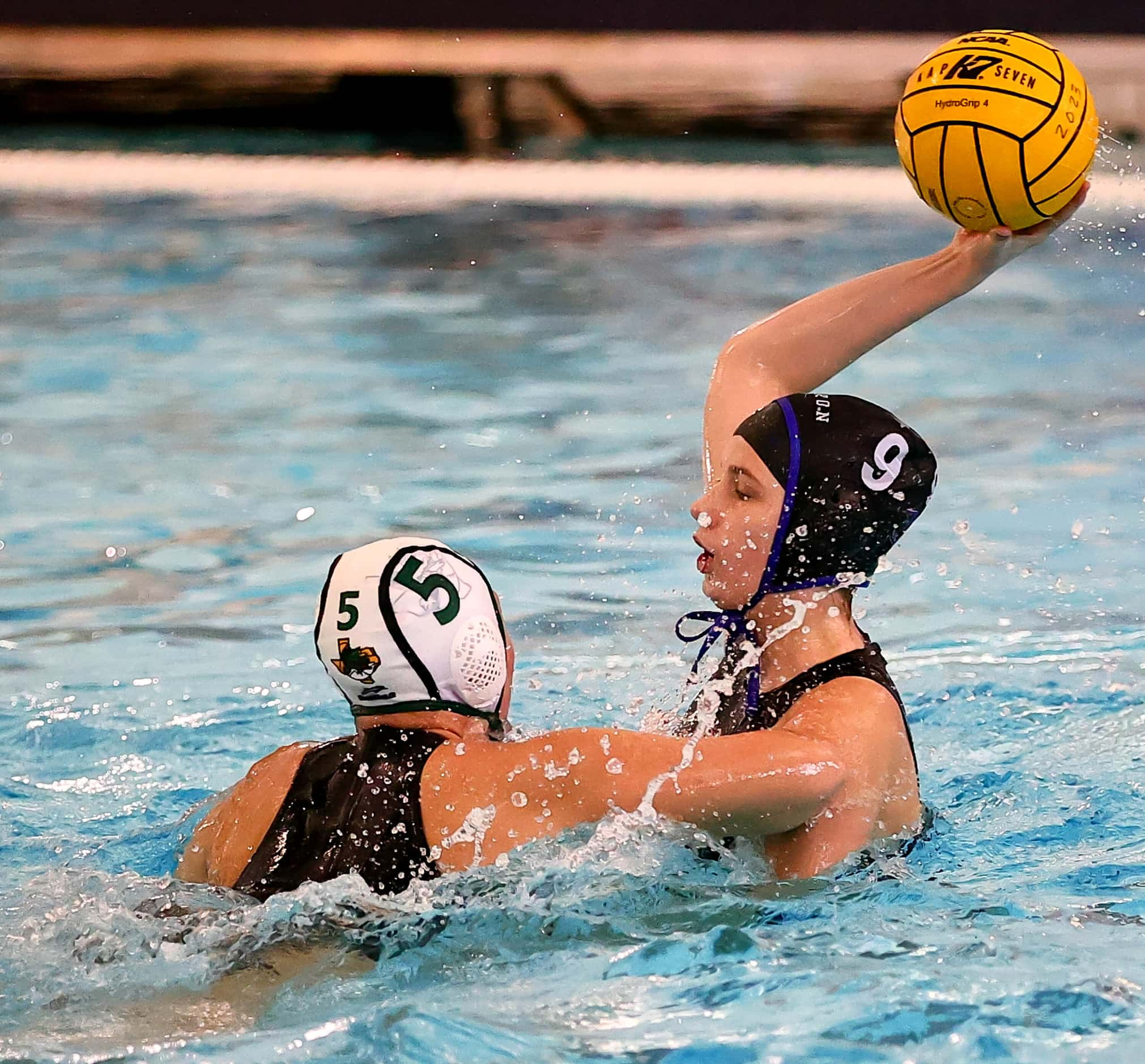 Hebron's Mia Slaughter (9) looks to make a pass against Southlake Carroll's Chloe Criswell...