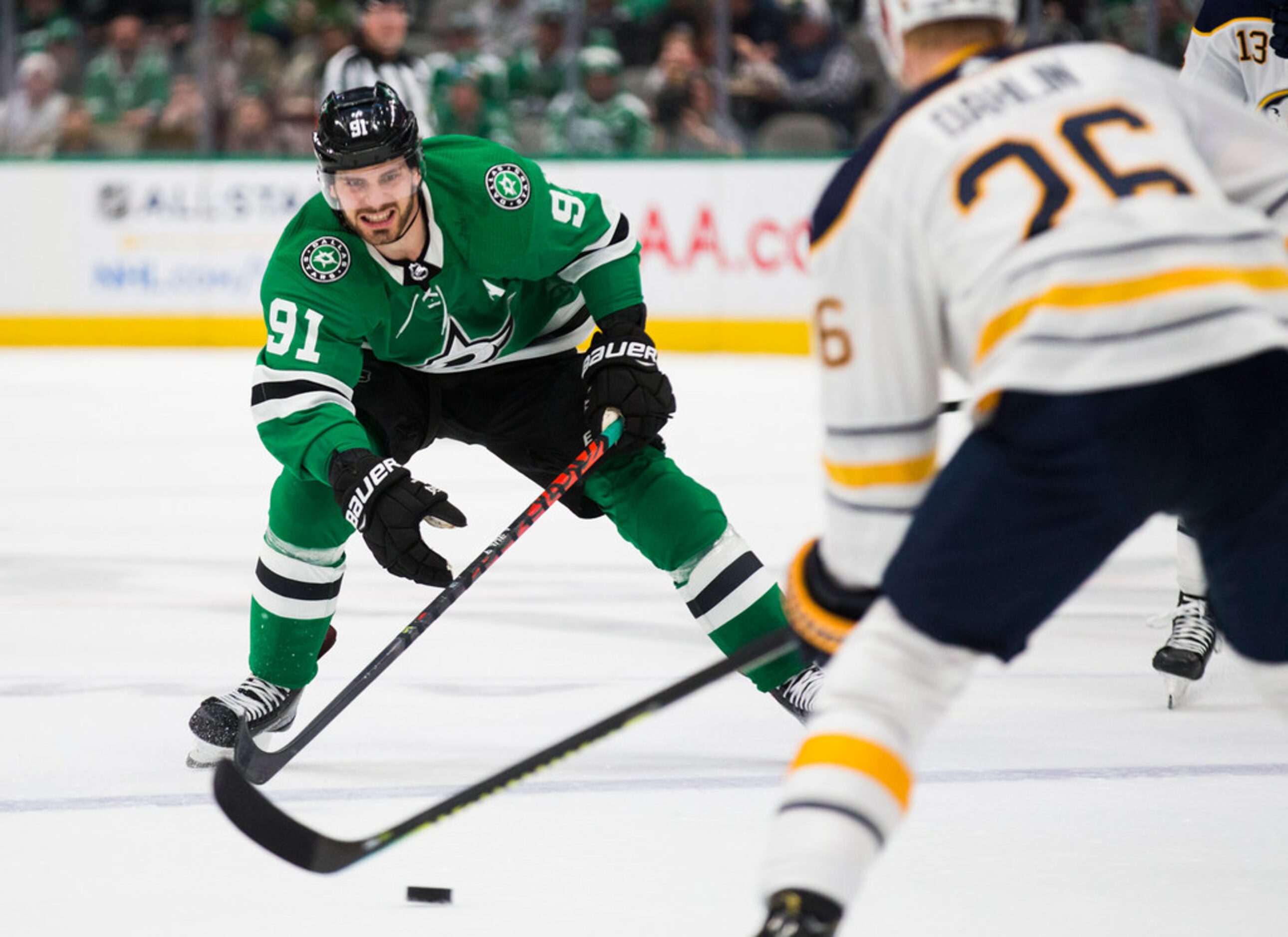 The Dallas Stars' Tyler Seguin (91) looks to get the puck from the Buffalo Sabres' Rasmus...