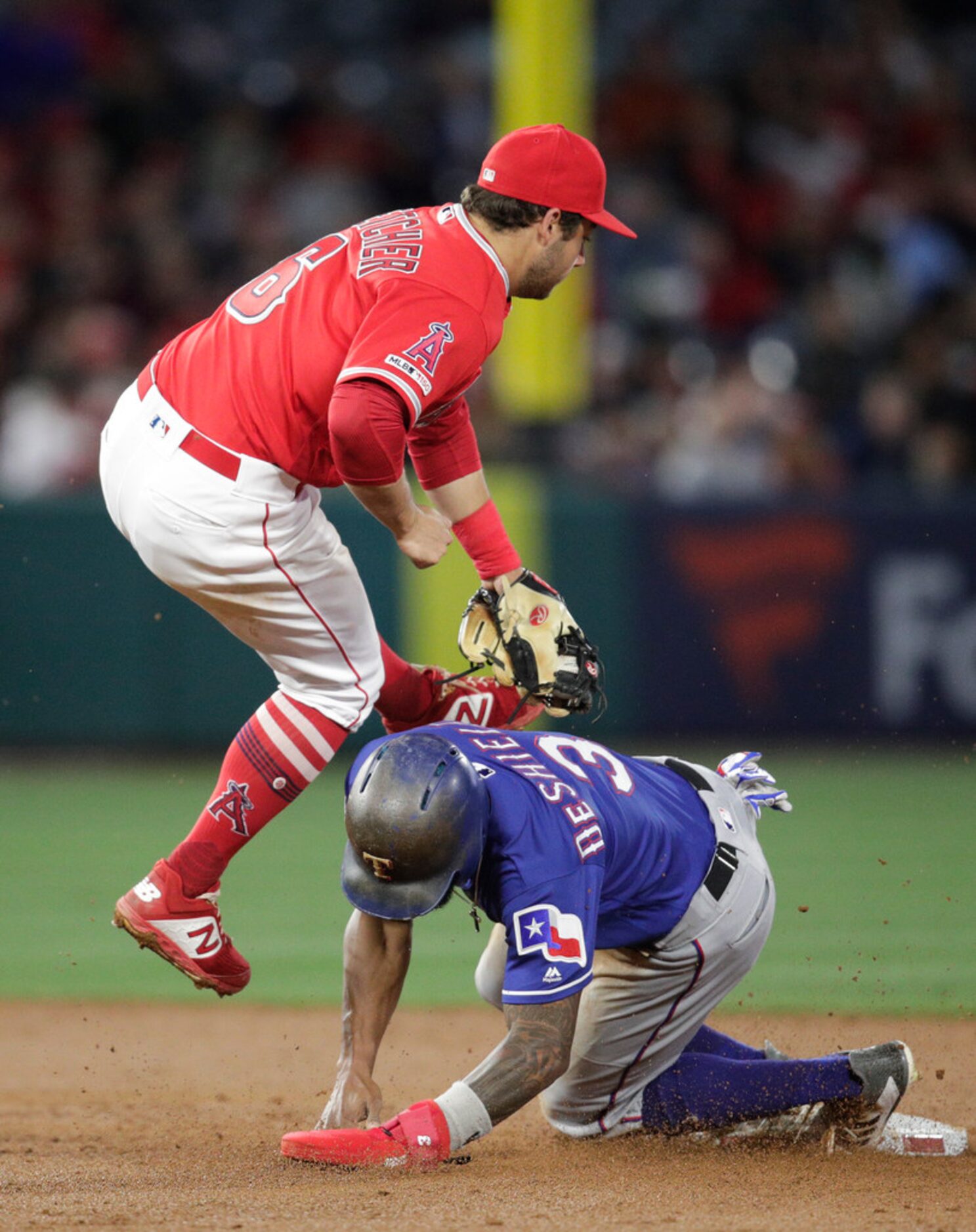 Texas Rangers' Delino DeShields, bottom, steals second base against Los Angeles Angels'...