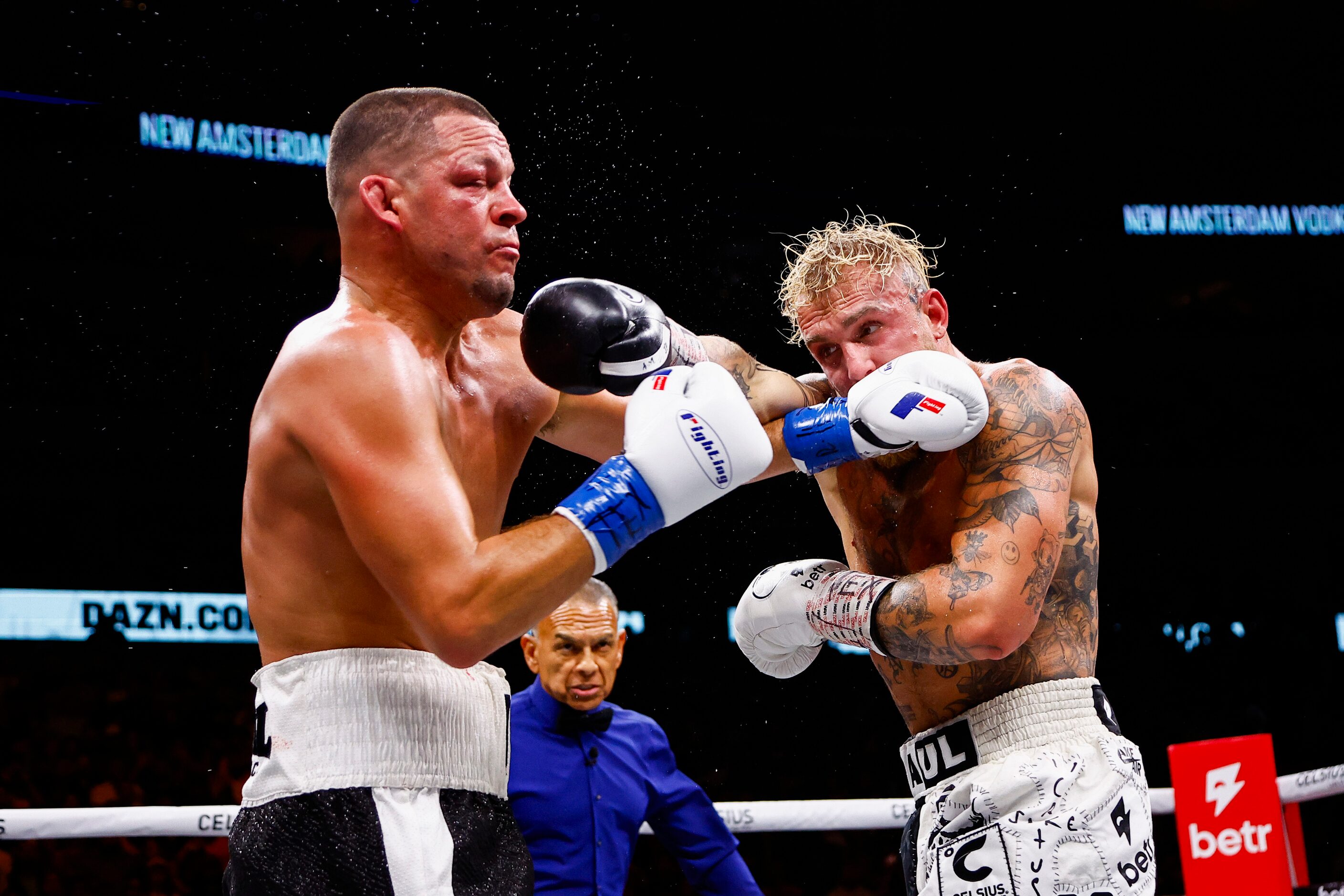 Nate Diaz, left, and Jake Paul land punches on each other during a boxing match in Dallas,...