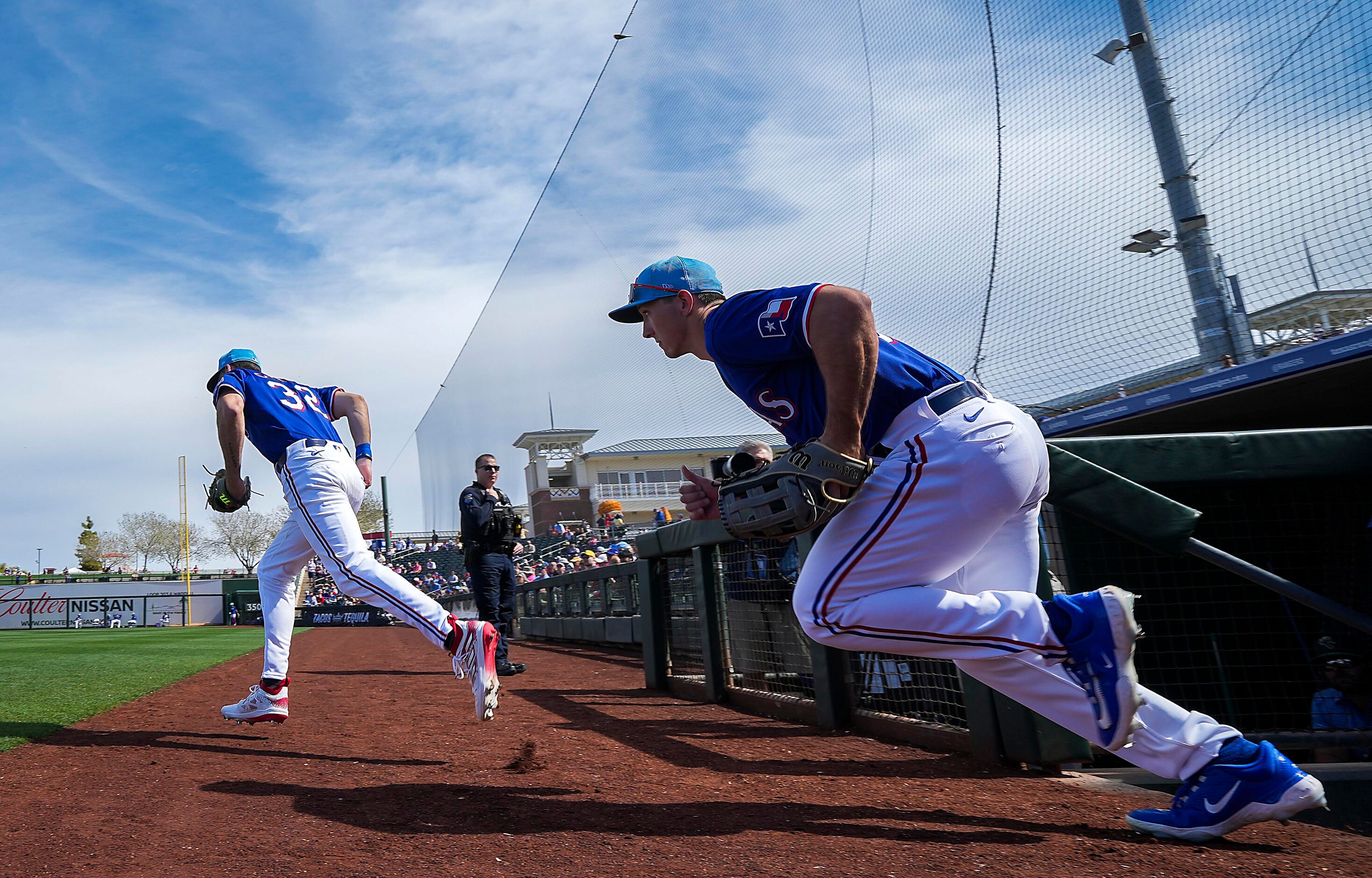 Texas Rangers outfielders Evan Carter (32) and Wyatt Langford take the field before their...