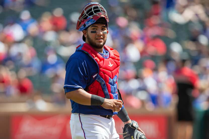 Texas Rangers catcher Jose Trevino walks back to home plate during the fifth inning of a...
