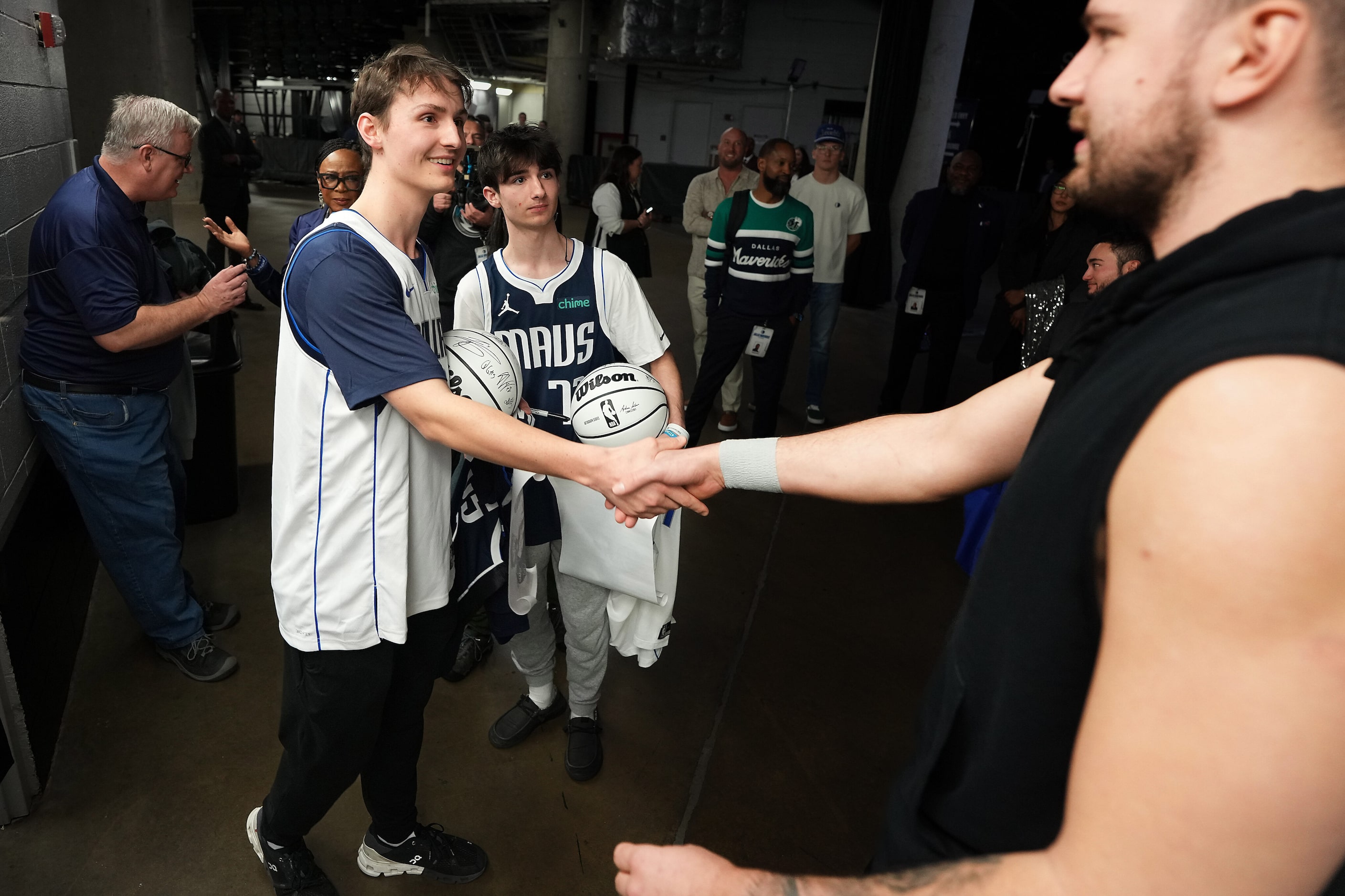 Dallas Mavericks guard Luka Doncic greets Make-A-Wish participant Thomas Marshall III (left)...