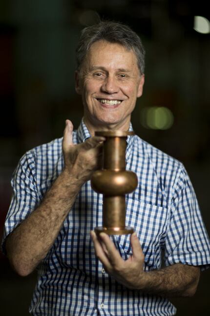 John Buttles, President of Bailey Tool & Manufacturing poses for a portrait with a...