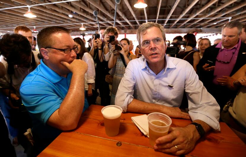 Republican presidential candidate former Florida Gov. Jeb Bush talks with Chris McLinden, of...