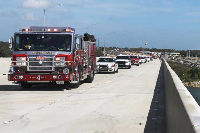 A Lewisville firetruck leads the way Wednesday across the new bridge after a ceremony...