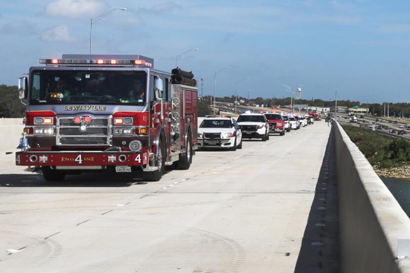 A Lewisville firetruck leads the way Wednesday across the new bridge after a ceremony...