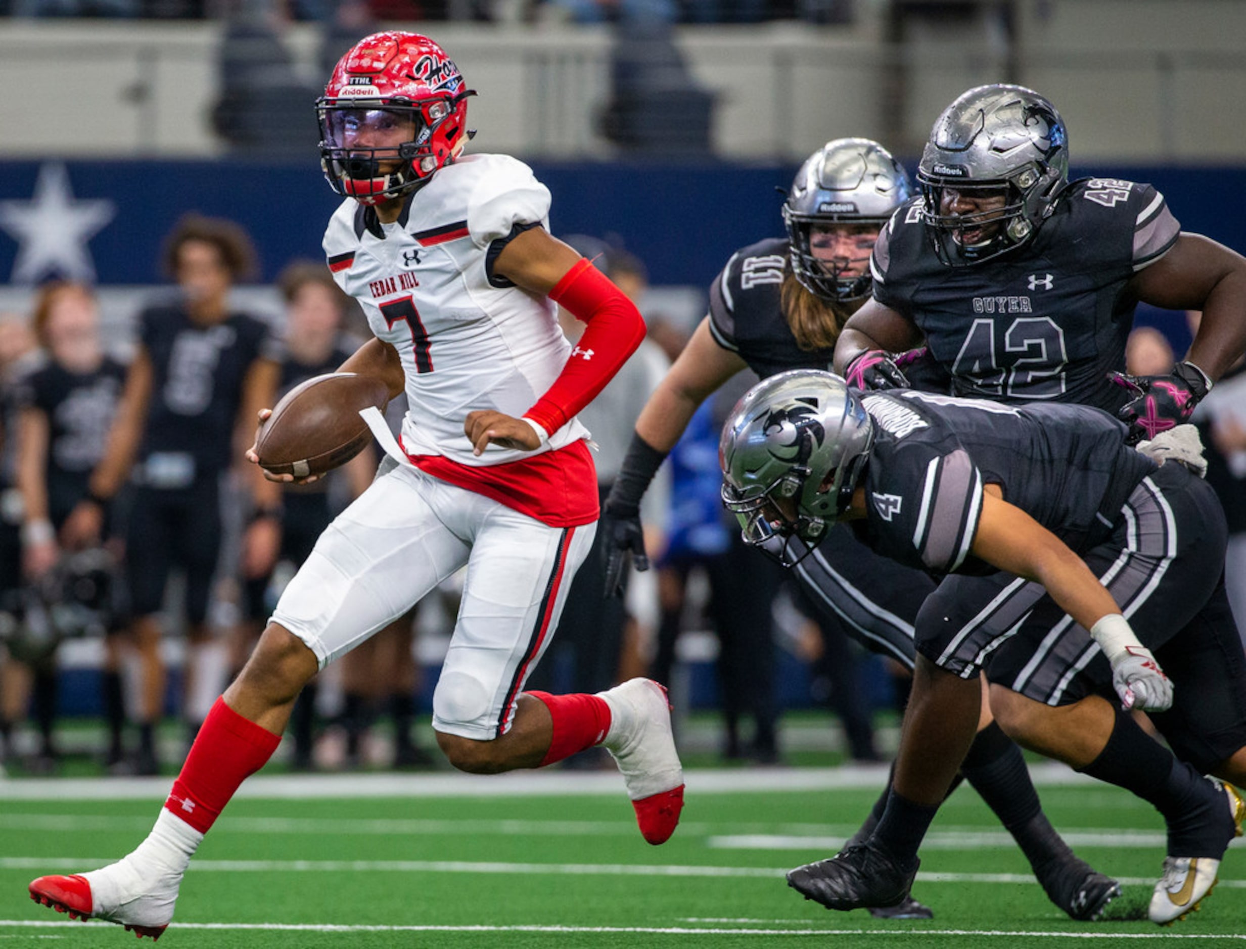 Cedar Hill quarterback Kaidon Salter (7) maneuvers past Denton Guyer defense during the...